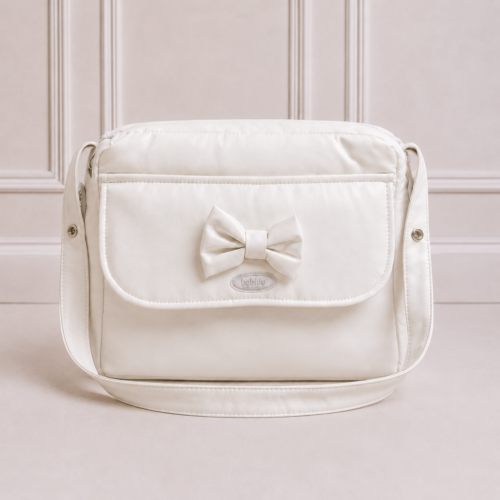White luxury nappy bag with bow detail on a soft neutral background. Elegant designer baby changing bag for stylish parents in South Africa.