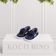 Boys navy boat shoes by Koco Bino featuring Velcro straps, contrast stitching, metal eyelets and textured soles for a classic smart-casual look.