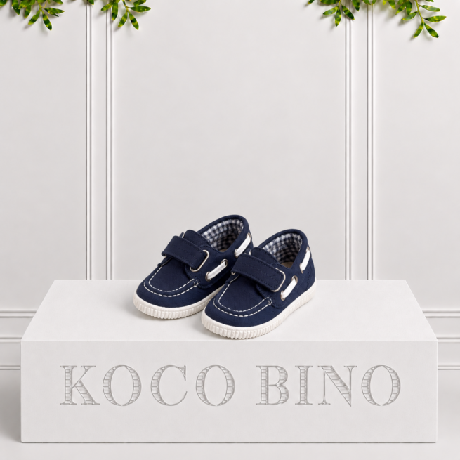 Boys navy boat shoes by Koco Bino featuring Velcro straps, contrast stitching, metal eyelets and textured soles for a classic smart-casual look.