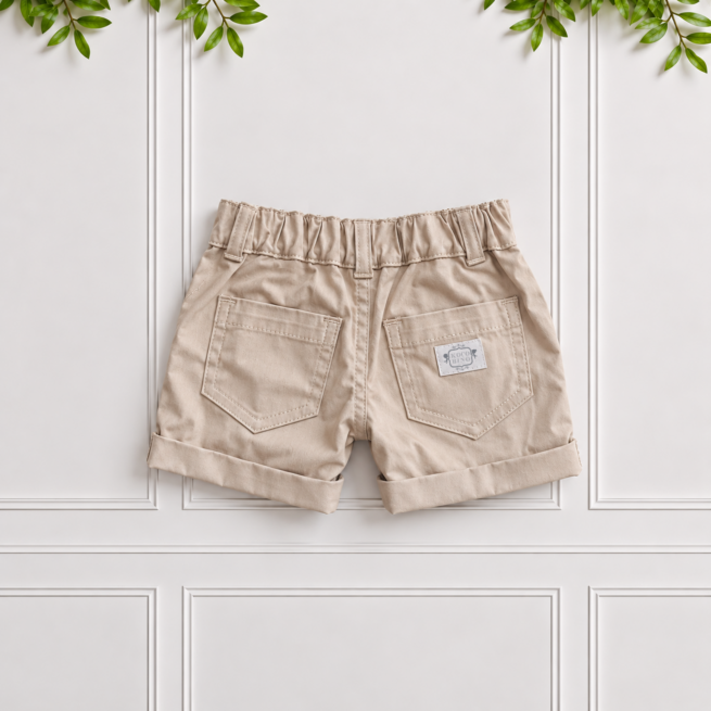 Back of boys stone cotton shorts with classic front pockets, belt loops and turned-up cuffs, displayed flat against a white panelled background.