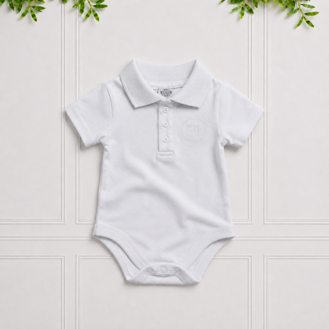 White short-sleeved baby boy bodyvest with a classic collar and embroidered KB crest, crafted from soft cotton for everyday comfort and style.