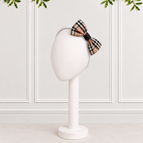 Stone Tartan Bow with black hoop on white Alice band. Beautifully presented against a white panelled background.