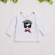 Becca Top in white with long sleeves, gold shoulder buttons and a chic fashion girl print for a playful, stylish look.