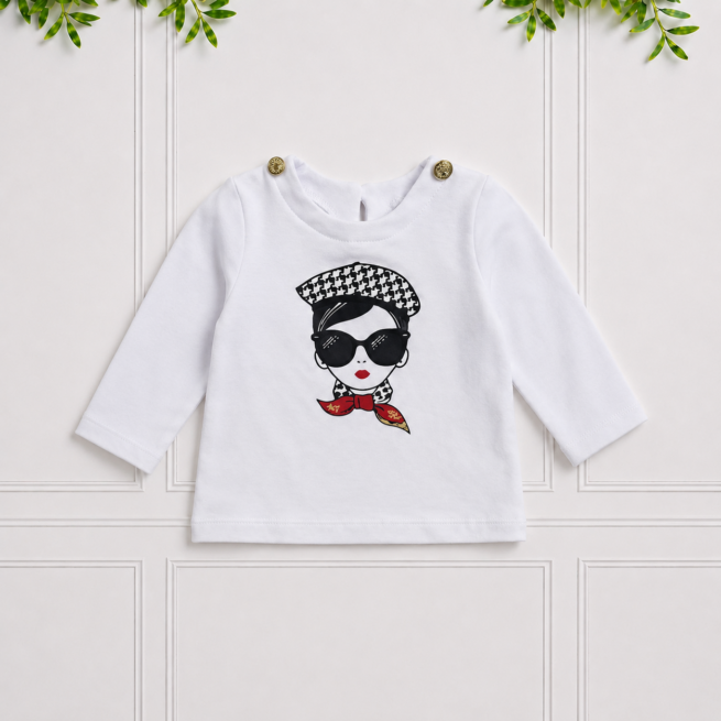 Becca Top in white with long sleeves, gold shoulder buttons and a chic fashion girl print for a playful, stylish look.
