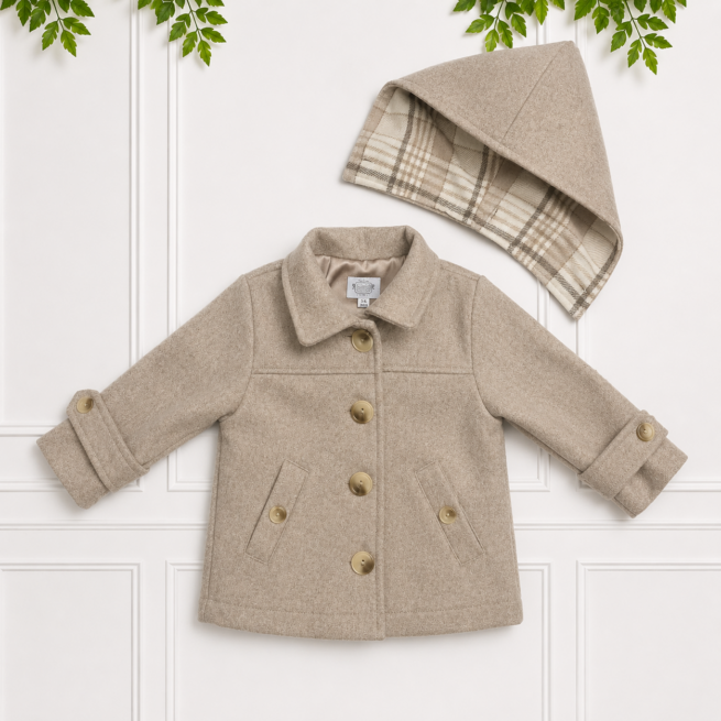 Beige children's coat with classic button front and matching plaid-lined hood, displayed flat on a white paneled background with green foliage.