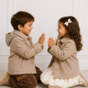 Boy & Girl wearing our unisex Gabriel Coat while playing with each other.