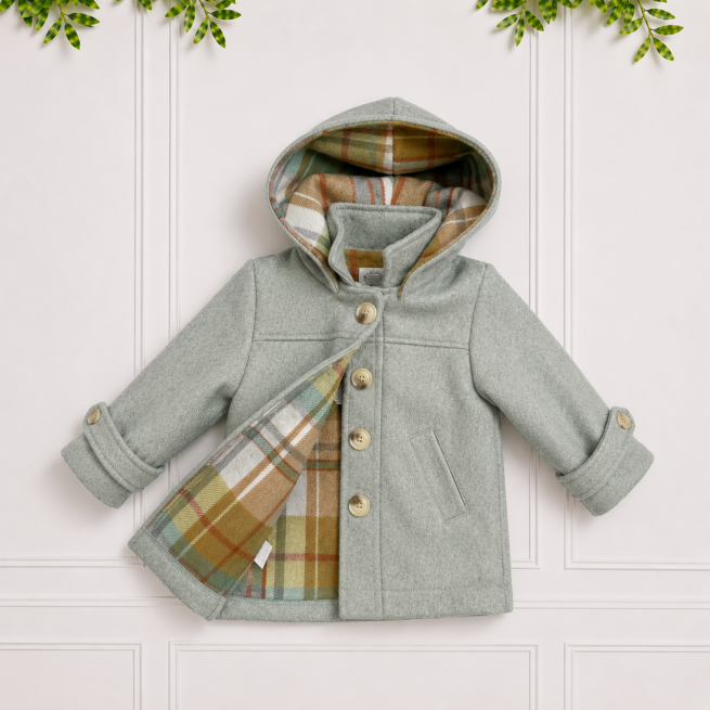 Shaun Coat in sage green with a detachable hood, plaid lining, button front and cosy rolled cuffs for timeless winter style.