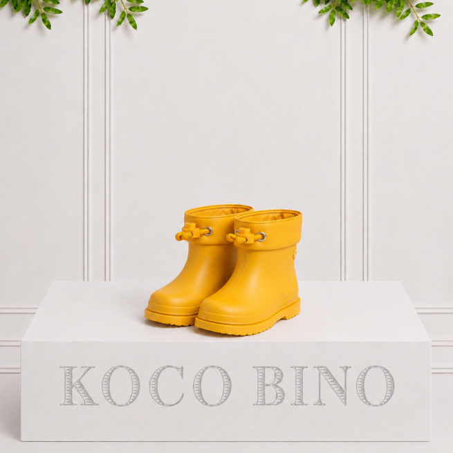 Yellow children's ankle rain boots with a matte finish featuring pull tabs.