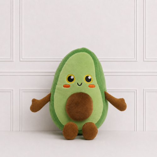 Soft avocado plush toy with embroidered smiling face, rosy cheeks and plush seed, displayed on a neutral background for nursery décor.