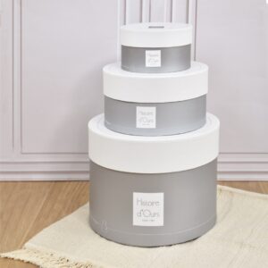 Histoire d'Ours luxury round gift boxes in three sizes, stacked in a nursery setting, perfect for premium baby gifts and keepsake storage.