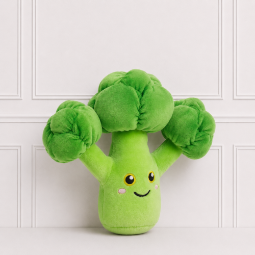 Soft green broccoli plush toy with embroidered smiling face, rosy cheeks and fluffy florets, displayed on a neutral background for nursery décor.