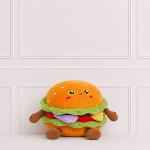 Soft burger toy with embroidered smiling face, sesame seed bun, lettuce, cheese and tomato, displayed on a neutral background for décor.