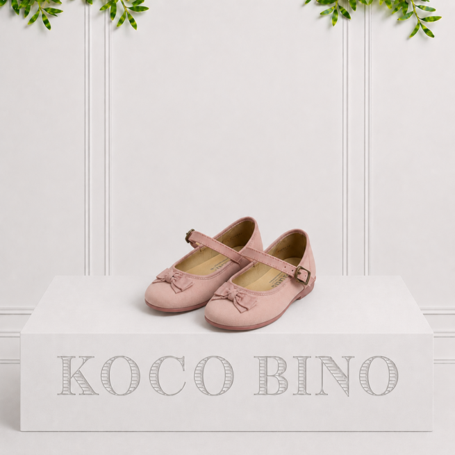 Soft pink children's Mary Jane pumps with delicate bow details and a buckle strap, perfect for special occasions and everyday wear.