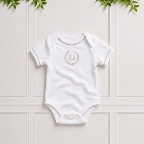 White baby vest in soft cotton interlock with elegant stone piping and stone KB embroidery, perfect for newborn comfort and everyday wear.