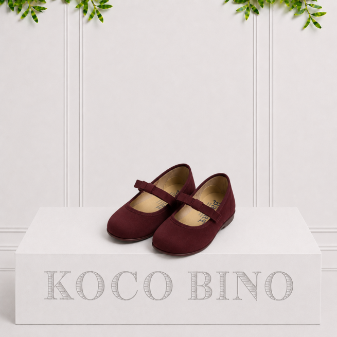 Elegant burgundy children's buckle pumps with a soft finish, designed for special occasions and everyday comfort.