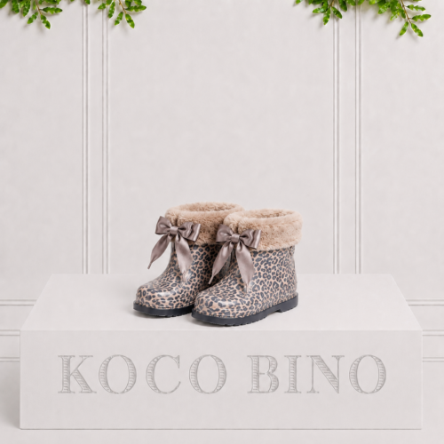 Children's leopard print rain boots with soft faux fur trim and satin bows, combining cosy warmth with playful rainy-day style.