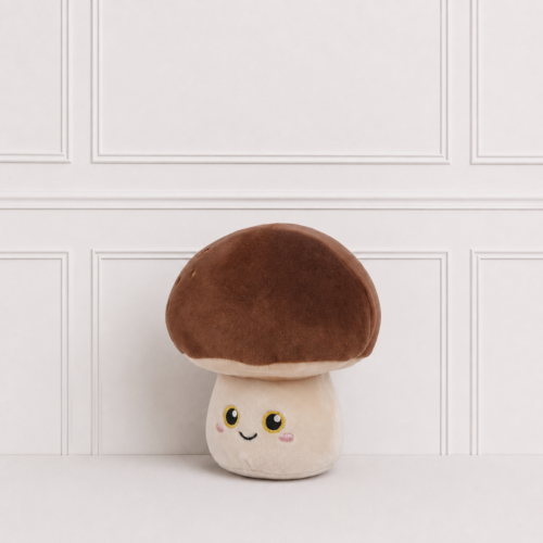 Cute mushroom plush toy with a soft brown cap, smiling embroidered face and rosy cheeks, displayed on a neutral background for nursery décor.