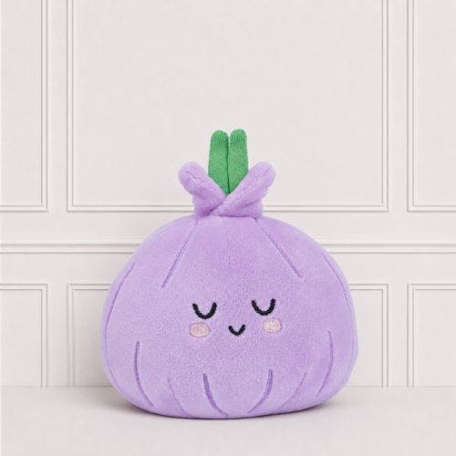 Soft purple onion plush toy with embroidered sleepy face, rosy cheeks and green stems, displayed on a neutral background for nursery décor.