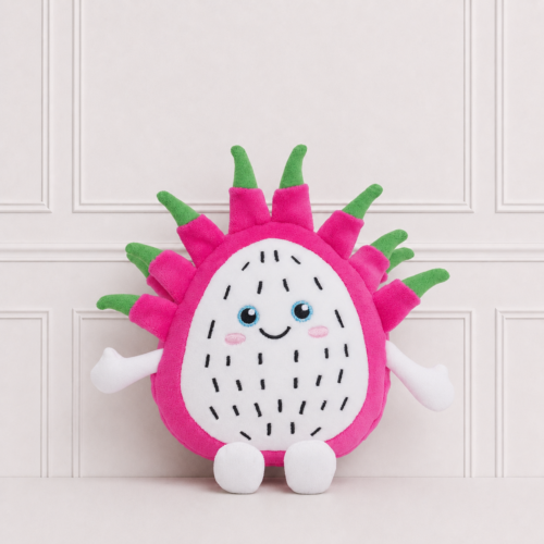 Pitaya soft toy with a smiling embroidered face, bright pink plush fabric and green leafy details, displayed against a classic white panelled backdrop.