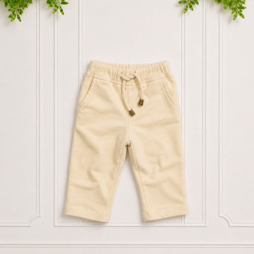 Cream track pants with a soft brushed finish, elasticated waistband, drawstring tie and relaxed straight-leg fit.