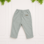 Relaxed-fit sage corduroy trousers for babies with functional pockets and a soft elastic waistband, presented in a clean studio flat lay.