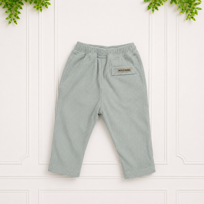 Relaxed-fit sage corduroy trousers for babies with functional pockets and a soft elastic waistband, presented in a clean studio flat lay.