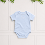 Blue baby bodyvest in soft cotton interlock with envelope neckline, white KB embroidery and white piping, displayed on a classic Koco Bino background.