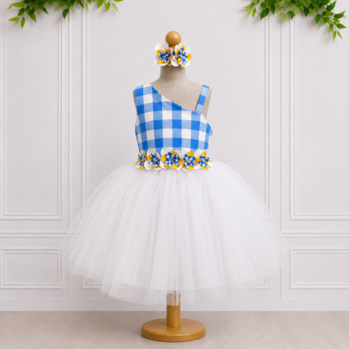 Girls flower girl dress in blue gingham with white tulle skirt and matching floral details, displayed on a mannequin for a special occasion.