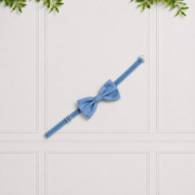 Boys' blue adjustable bow tie displayed on a white decorative background, perfect for weddings and special occasions.