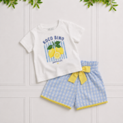 Girls' white lemon print T-shirt and blue gingham shorts with a yellow bow, styled together against a white panelled background.