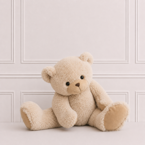 Soft teddy bear in a creamy beige plush finish, seated against a neutral backdrop. A cuddly companion and timeless gift for babies and young children.