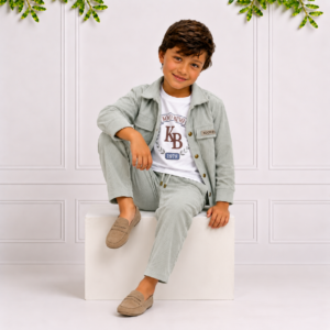Koco Bino boys clothes featuring a boy in a sage corduroy overshirt, matching trousers, graphic tee and loafers with timeless boutique style.