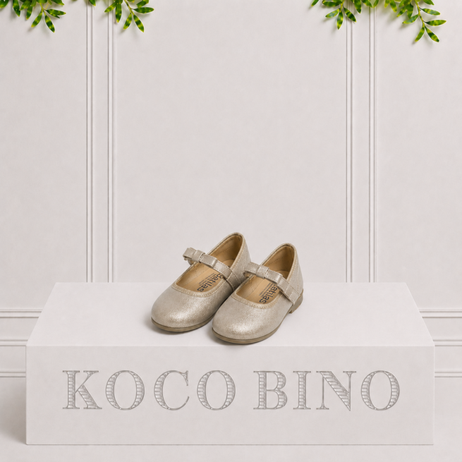 Gold girls' formal shoes with Mary Jane straps, displayed on a Koco Bino pedestal, perfect for weddings and special occasions.