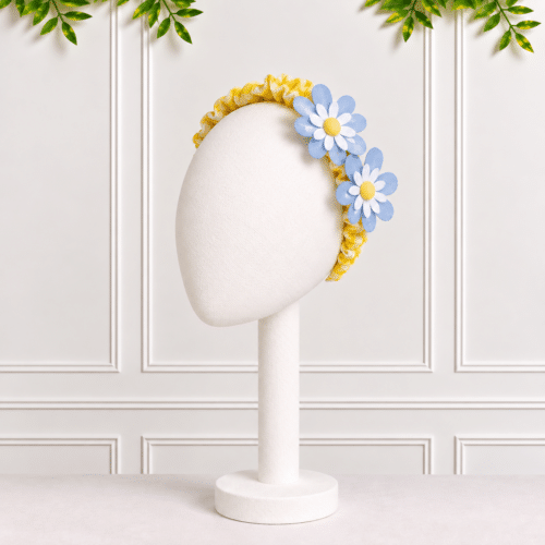 Baby girl flower headband in yellow and white seersucker gingham with blue and white laser-cut daisy flowers.