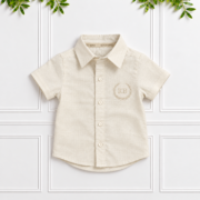 Boys’ cream 100% linen short-sleeve shirt with classic collar and cream KB monogram embroidery.