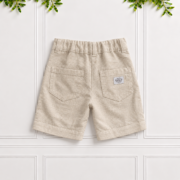 Boys stone linen shorts with back patch pockets, belt loops, elastic waistband and natural linen texture, displayed against a white panelled background.