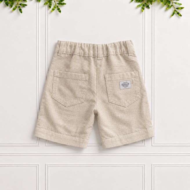 Boys stone linen shorts with back patch pockets, belt loops, elastic waistband and natural linen texture, displayed against a white panelled background.