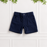 Boys Navy Cotton Shorts by Koco Bino featuring a button fastening, belt loops, front pockets and classic turn-up hems for a smart, timeless look.
