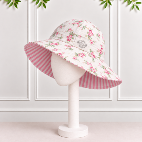 Girls’ Reversible Sunhat in Liberty floral print with pink and white striped seersucker lining and Koco Bino logo.