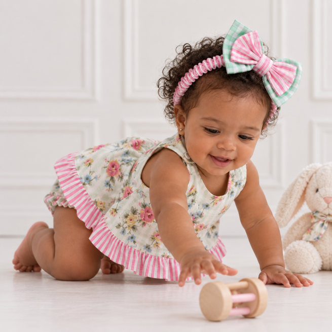 Baby Girl Reversible Set with floral print, sage green gingham and pink striped frills, styled on a baby girl with matching bow headband.