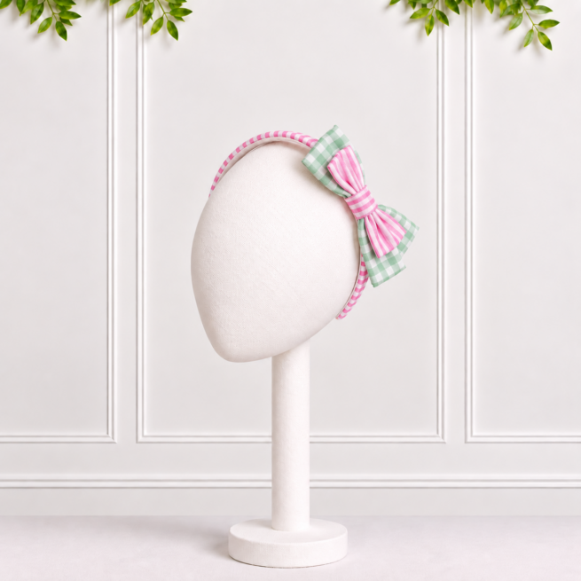Girls’ sage floral alice band with a pink striped bow and sage green gingham detailing by Koco Bino.